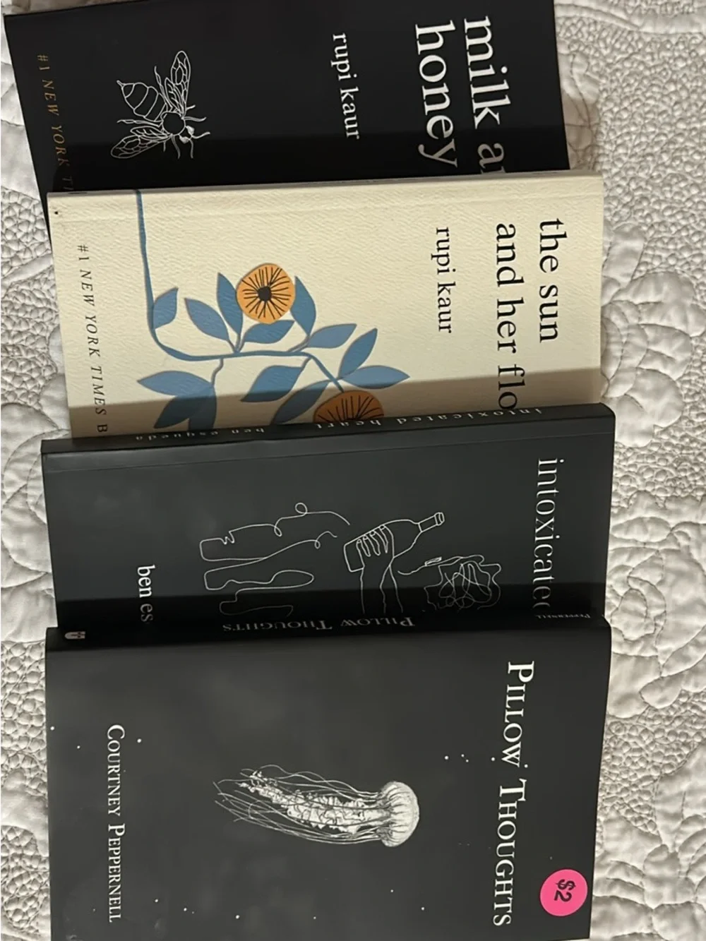 Collection of Decorative Paperback Books in Black, Cream, and Blue